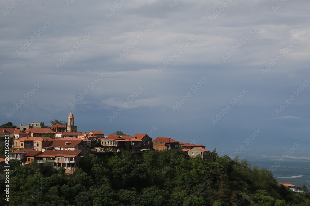 View of the tegular roofs and the church of the city Signagi (Sighnaghi), picturesquely situated on the top of a mountain in the Alazany Valley (Georgia)