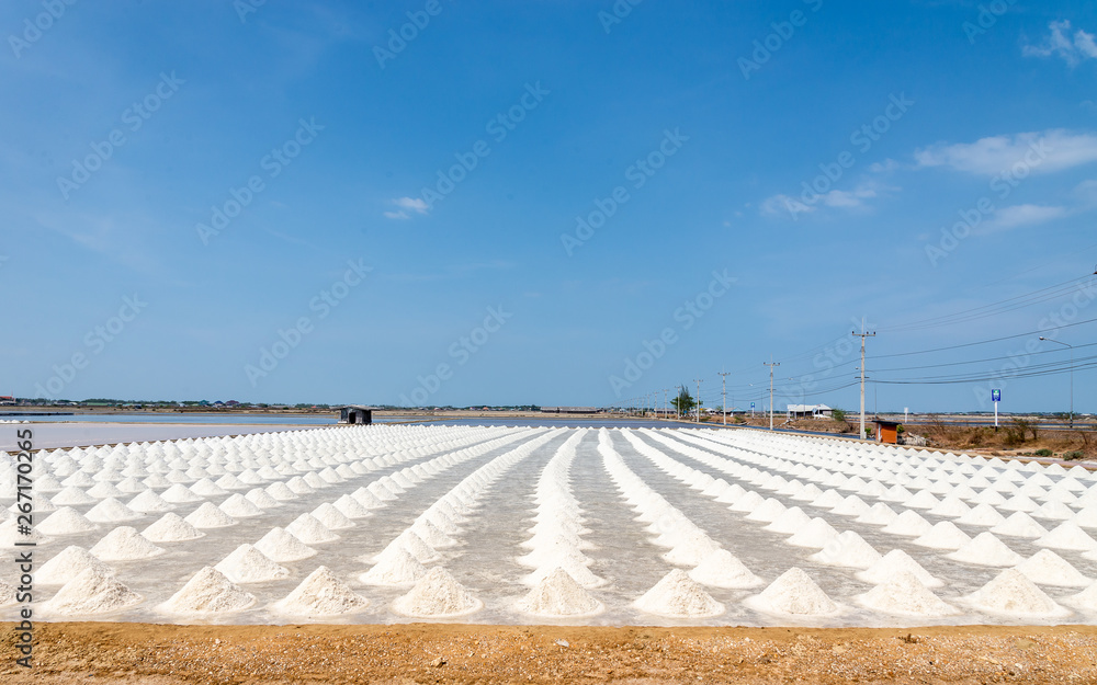 Heap of sea salt in salt farm ready for harvest Location Phetchaburi Province Thailand blue sky as background