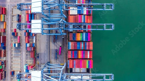 4k Hyper lapse aerial view container cargo ship loading and unloading in deep sea port, Aerial top view of logistic import export transportation business by container ship in open sea. photo