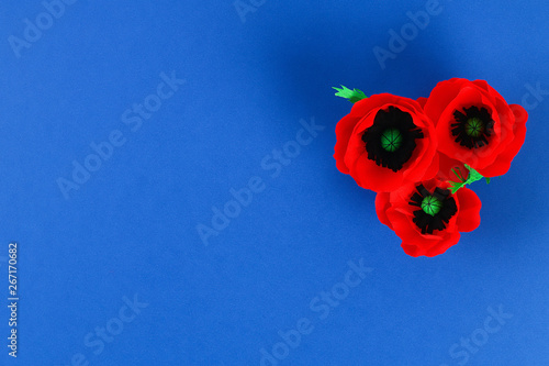 Diy paper red poppy Anzac Day, Remembrance, Remember, Memorial day crepe paper on blue background.