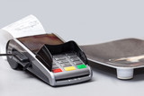 Non-cash payment terminal for payment using a bank card lies in the store on the table