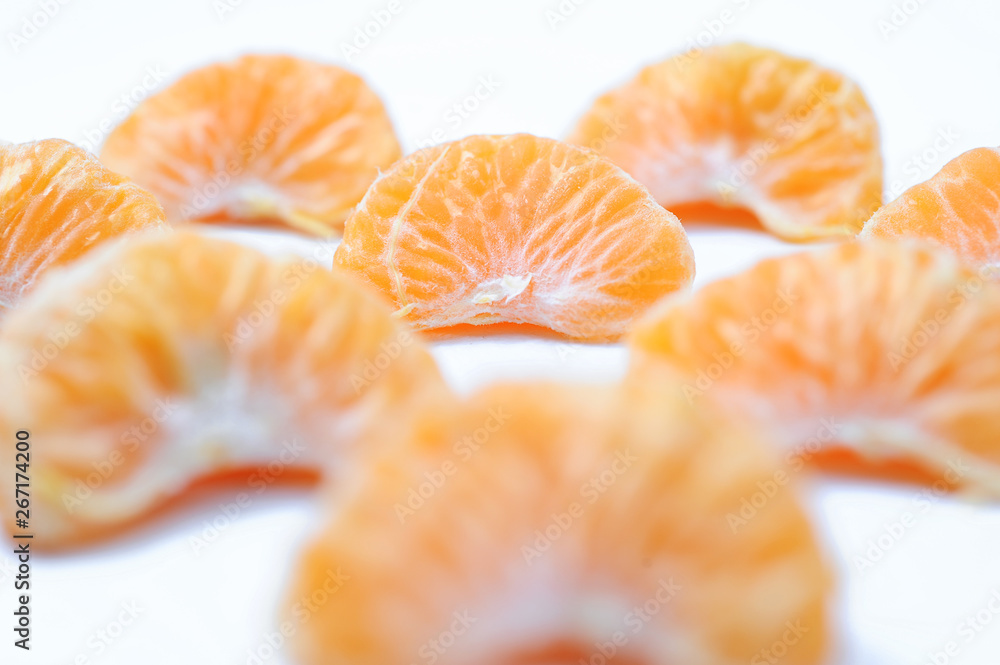 Isolated orange, Collection of whole orange or clementine fruits and peeled segments Isolated orange, Collection of whole orange or clementine fruits and peeled segments