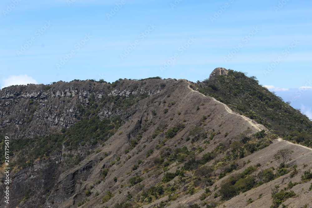  the clear sky above the volcanic crater that surrounds the clouds