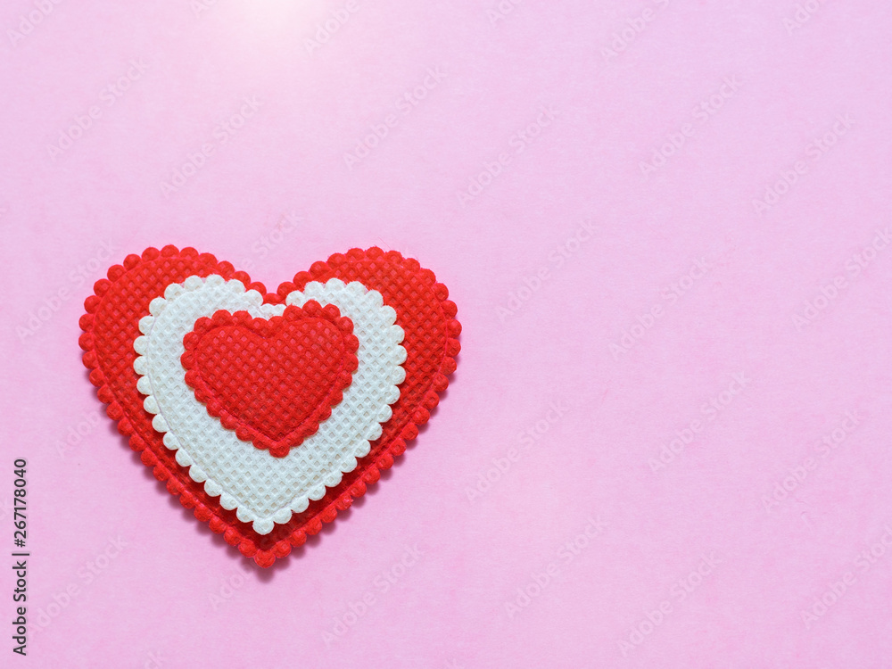 Bright red and white heart on light pink background. The view from the top. Flat lay.