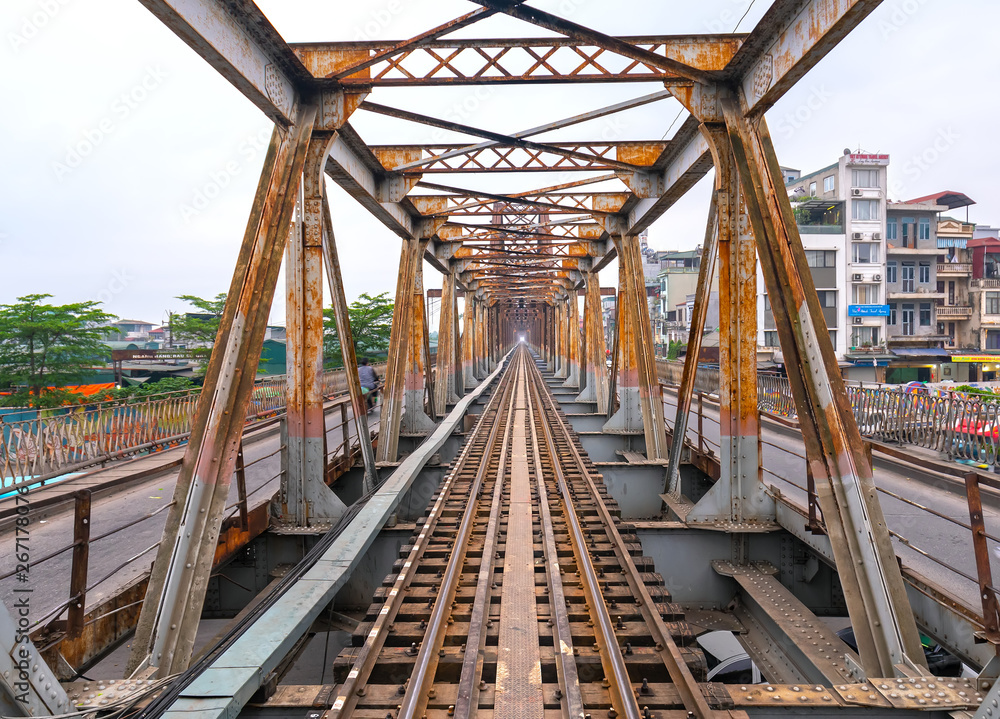 Vintage railroad tracks leading over the famous Long Bien Bridge, Hanoi, Vietnam. This is the railway line was built so long and still in operation today