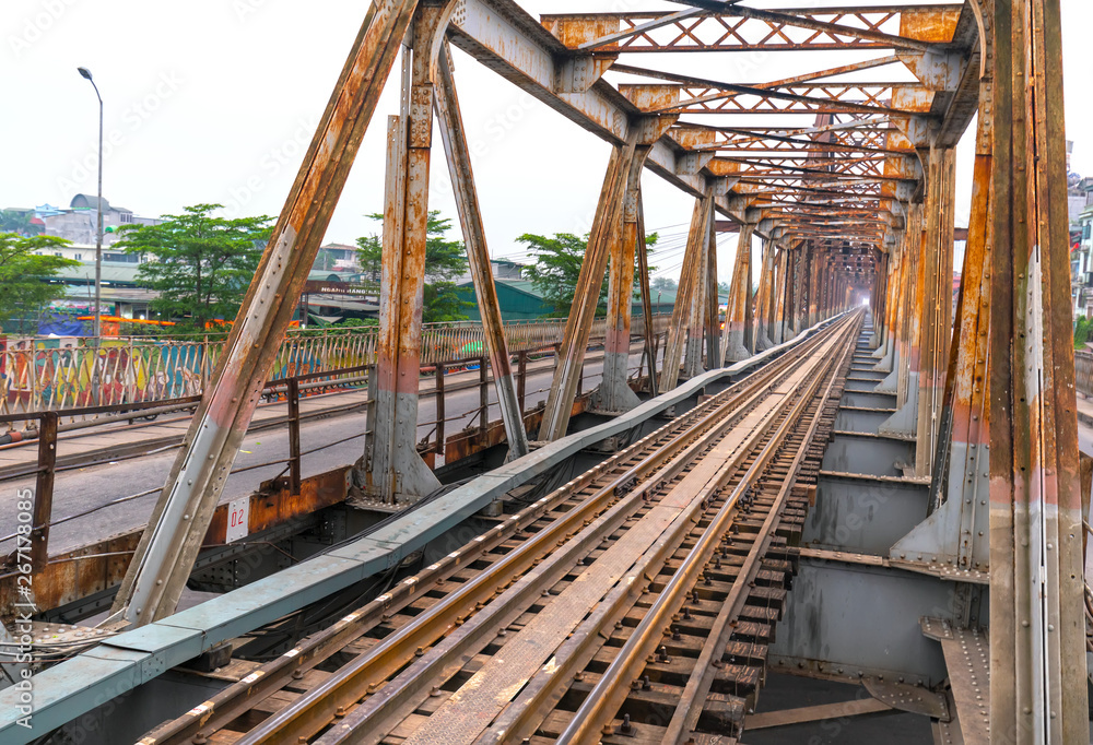 Vintage railroad tracks leading over the famous Long Bien Bridge, Hanoi