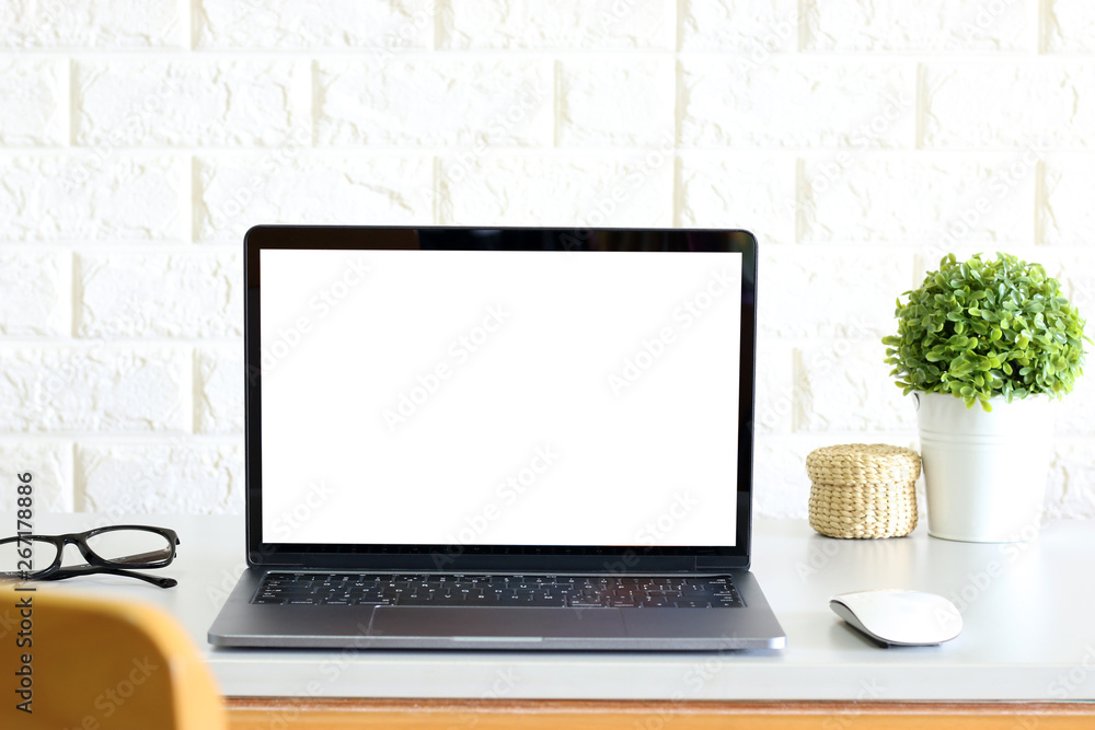blank screen Modern laptop computer with mouse,Smart phone and Succulent on wood table in office view backgrounds blank screen Modern laptop computer with mouse,Smart phone and Succulent on wood table in office view backgrounds