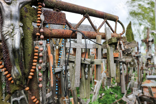 Wooden crosses on large rusty iron cross closeup