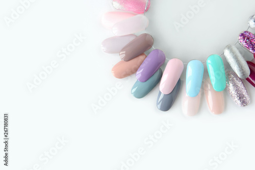 Nail polish samples in different bright colors. Colorful nail lacquer manicure swatches. Top view of nail art wheel palette.