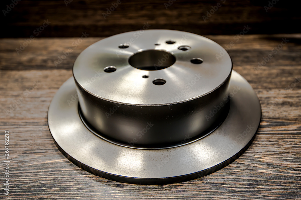 Car brake diske on wooden background Car brake diske on wooden background