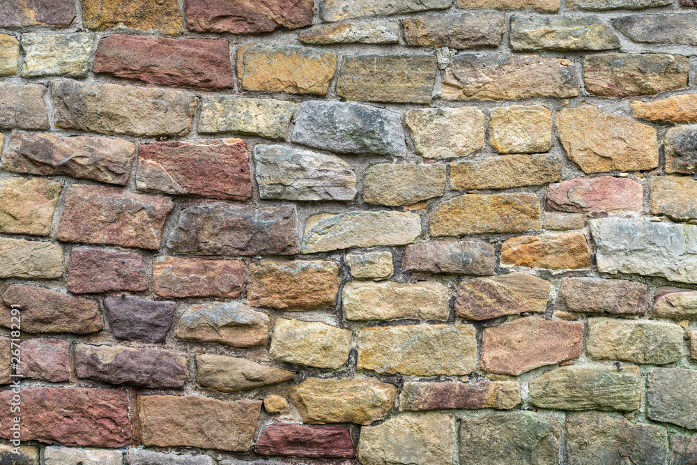 Obraz premium Stone texture. Colorful rock wall. Wall of colored stones bonded with cement.
