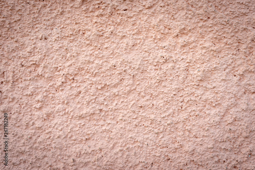Texture of peach color stucco wall. Close up stucco background.