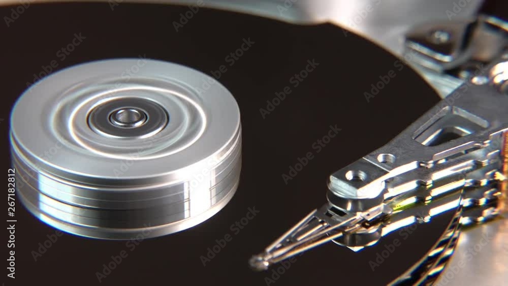 Close-up of an operating computer harddisk reading and writing data Close-up of an operating computer harddisk reading and writing data