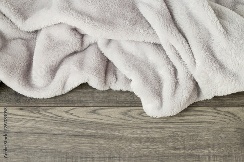Grey blanket on wooden background