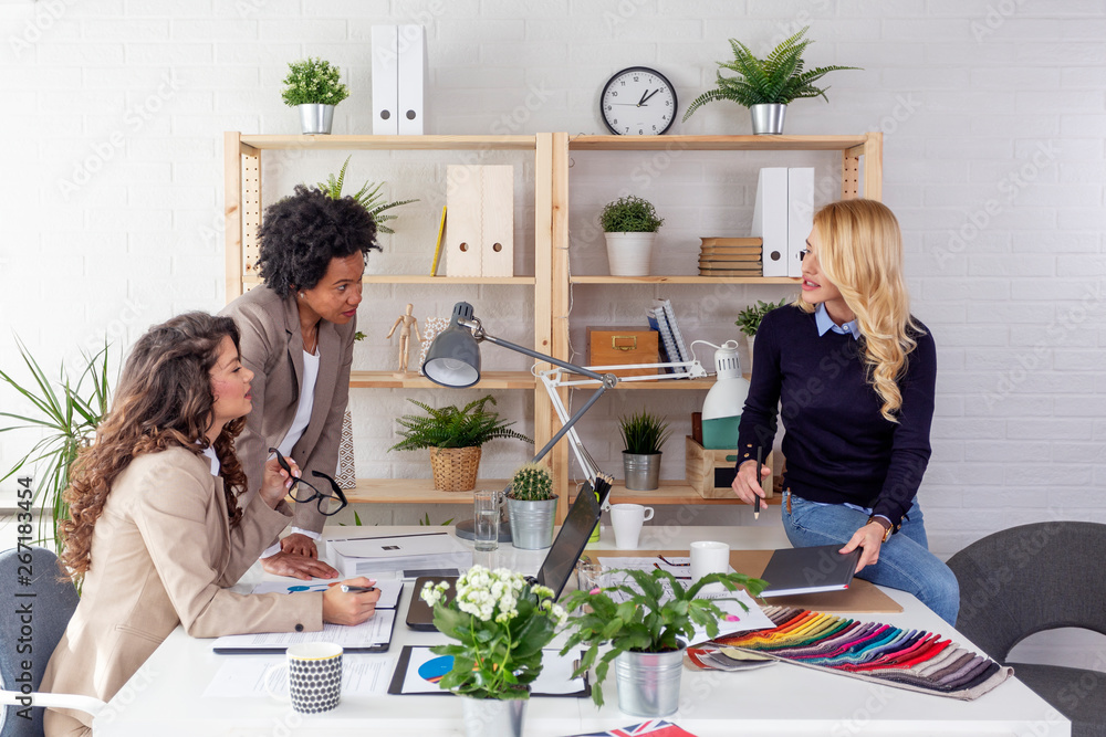 Three multiethnic woman working at the office and discuss about job Three multiethnic woman working at the office and discuss about job