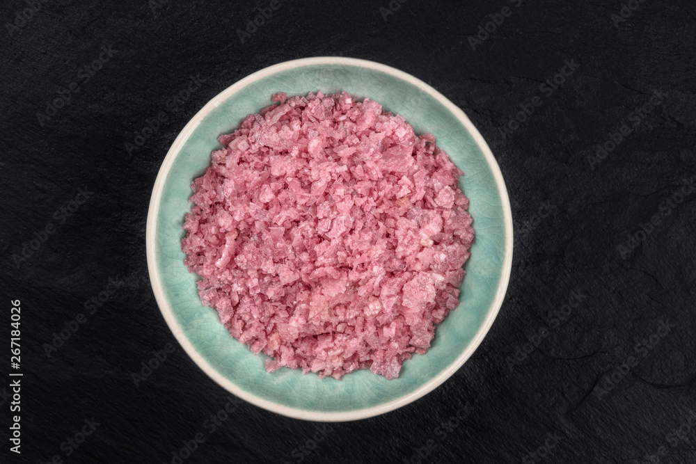 Pink Himalayan sea salt, shot from the top on a dark background with a place for text Pink Himalayan sea salt, shot from the top on a dark background with a place for text