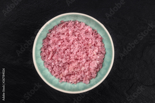 Pink Himalayan sea salt, shot from the top on a dark background with a place for text