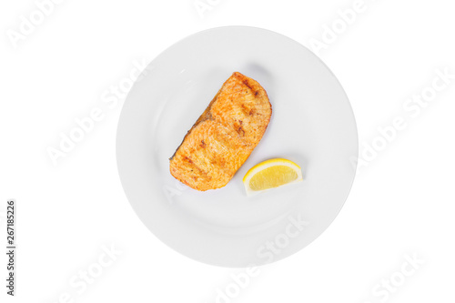 Fish, trout, keta, pink salmon, a piece, baked, fried over an open fire with a slice of lemon. Appetizing on white isolated background view from above photo