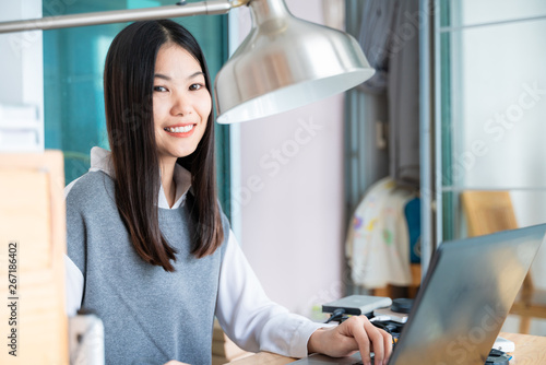 Business asian women in office with laptop