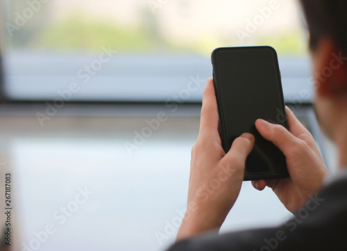 Mock up of a business man holding smartphone device