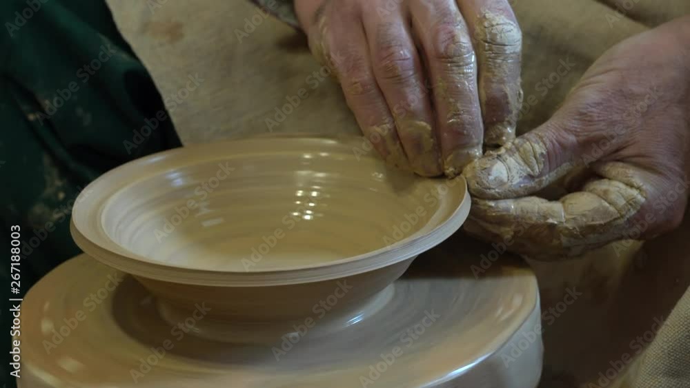 Creating vase of white clay close-up. The sculptor in workshop makes jug out of clay closeup. Creating vase of white clay close-up. The sculptor in workshop makes jug out of clay closeup.