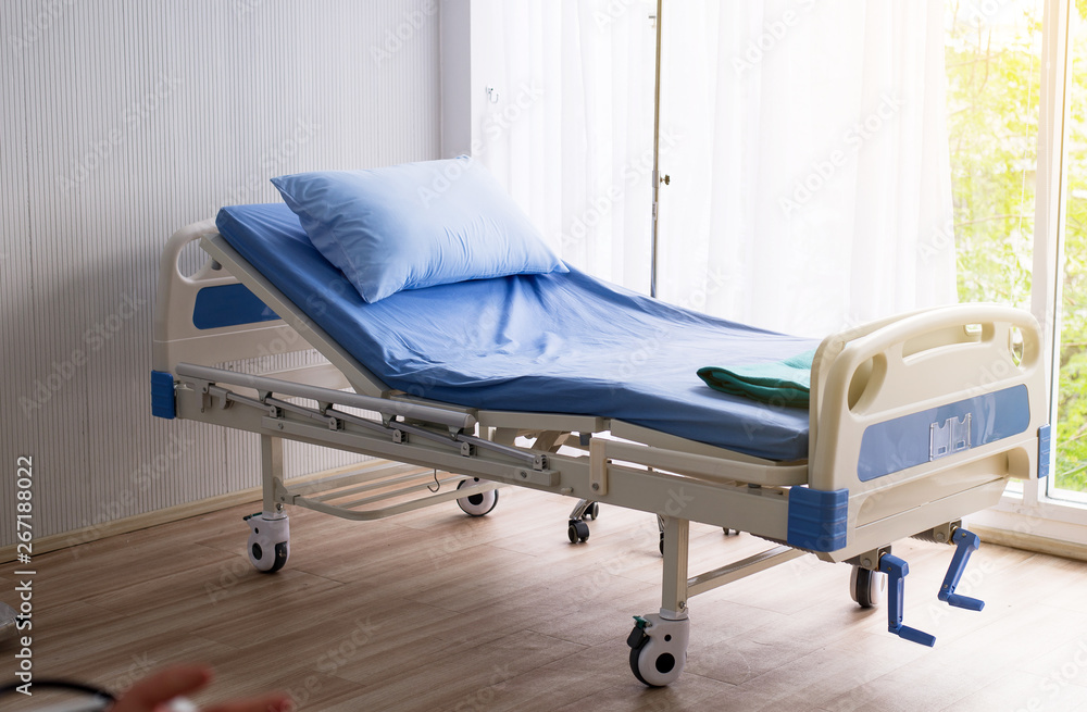 Empty sick bed at hospital room for supporting patients Empty sick bed at hospital room for supporting patients