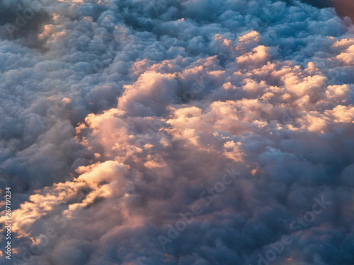 Beautiful clouds scape from airplane window at sunset.