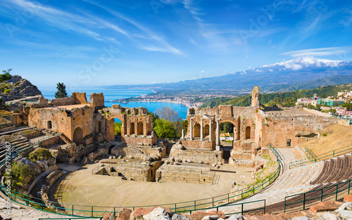Ancient Greek theatre in Taormina on background of Etna Volcano, Italy photo