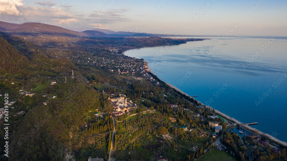Aerial photography. New Athos monastery. Abkhazia. View of the black sea coast. Sunset over the sea and shore.