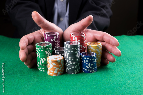 Quadro su tela Poker player going all in pushing his chips forward on the table