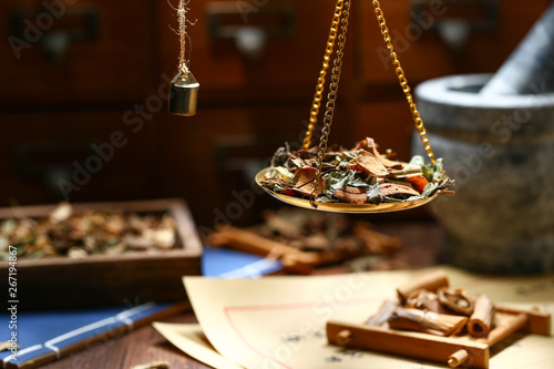 Chinese traditional herbal medicine in steelyard. Translation reads as chinese herbal therapy.
