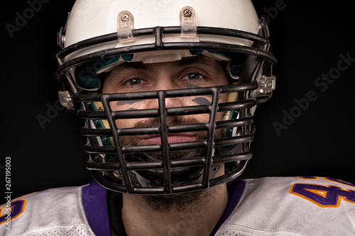 Portrait close-up, American football player, bearded in helmet. Concept American football, patriotism, close-up. © Georgii