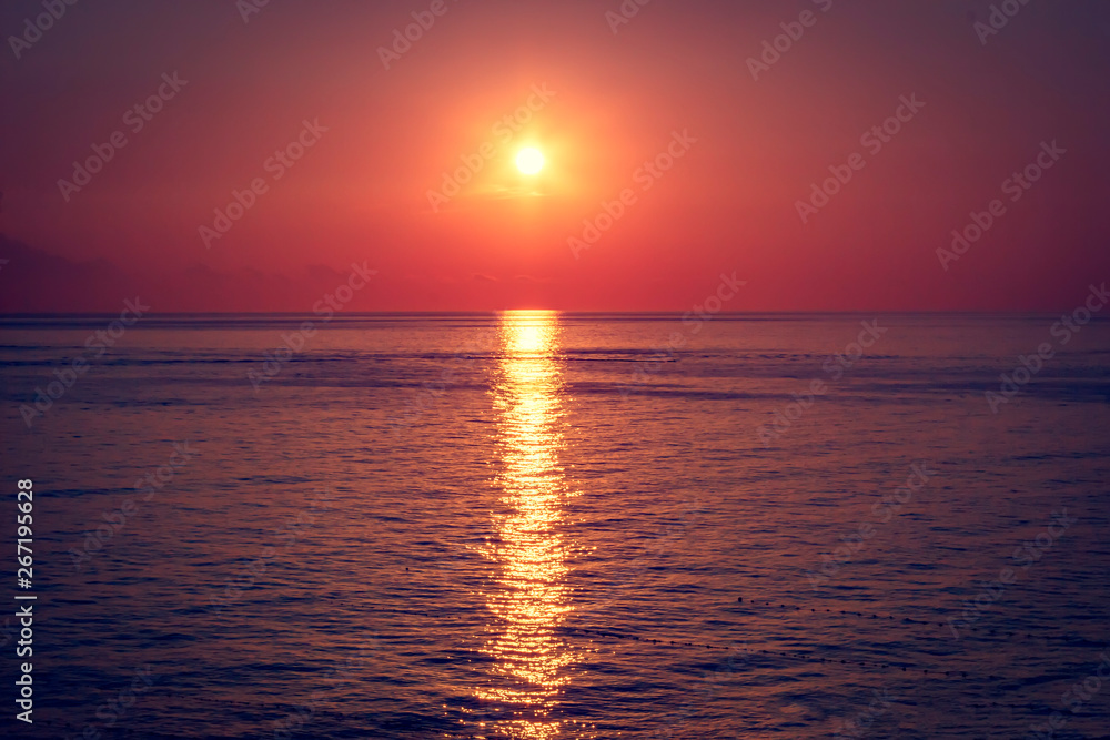 Beautiful red sunset over dark sea. Summer background.