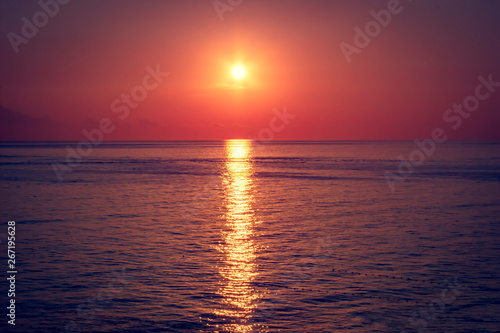 Beautiful red sunset over dark sea. Summer background. © sergofan2015