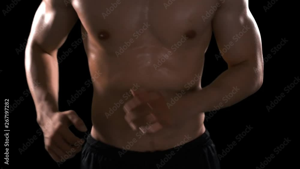 Unrecognizable muscular man workout in the studio by running in place. Shot in 4k resolution with dark background Unrecognizable muscular man workout in the studio by running in place. Shot in 4k resolution with dark background
