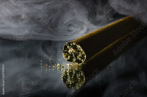Stylized Cannabis Blunt Photograph with weed crumbs and smoke in the background photo