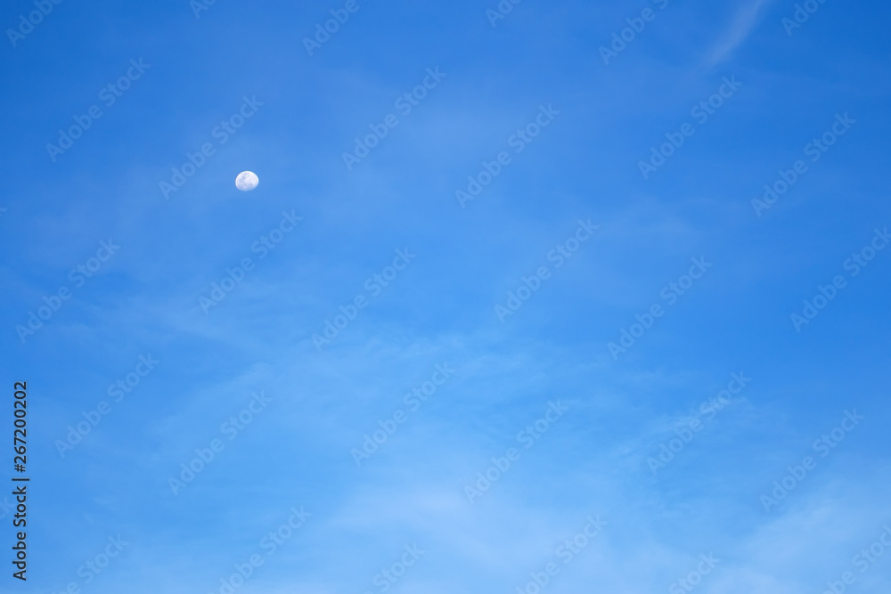 white moon on clear blue sky with cloud in the day and morning or evening on summer for scene and nature background with copy space white moon on clear blue sky with cloud in the day and morning or evening on summer for scene and nature background with copy space