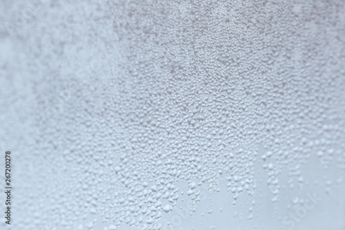 texture of water on the glass. Background of condensate or rain on the window. Selective focus