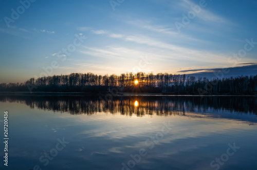 Sunset in summer by the lake. Summer minimalistic landscape in yellow and blue shades. There is a place for text. © Ольга Холявина