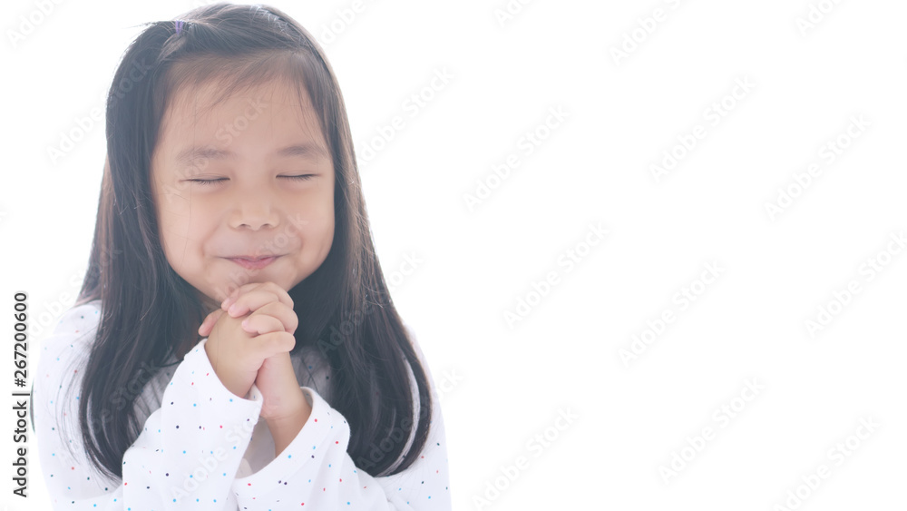 Asian child cute or kid girl smiling with hold hand and pray or beg and sorry for peaceful world and happy with wear white clothes on white space background isolated and wide screen Asian child cute or kid girl smiling with hold hand and pray or beg and sorry for peaceful world and happy with wear white clothes on white space background isolated and wide screen