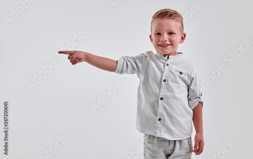 Little boy on gray background