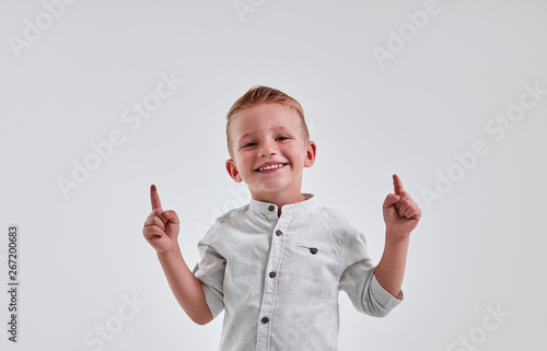 Little boy on gray background