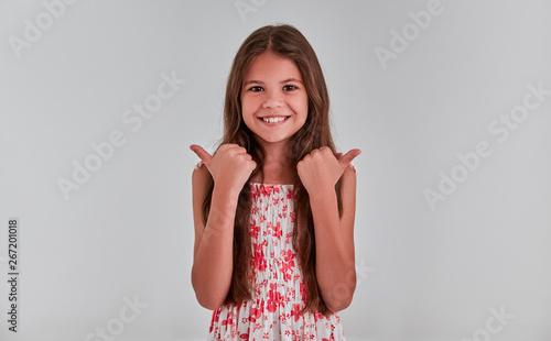 Cute girl on a gray background