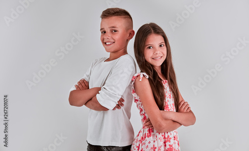Cute girl and boy on a gray background