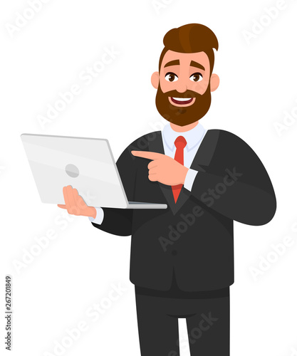 Smiling young bearded business man holding/showing latest brand new laptop computer device and pointing it with hand finger. Modern lifestyle, digital technology trend, portable gadget  in cartoon. photo