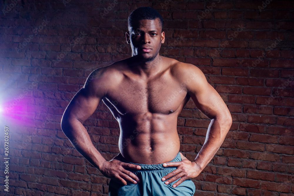 Fototapeta premium young muscular african american man doing push-ups and looking away