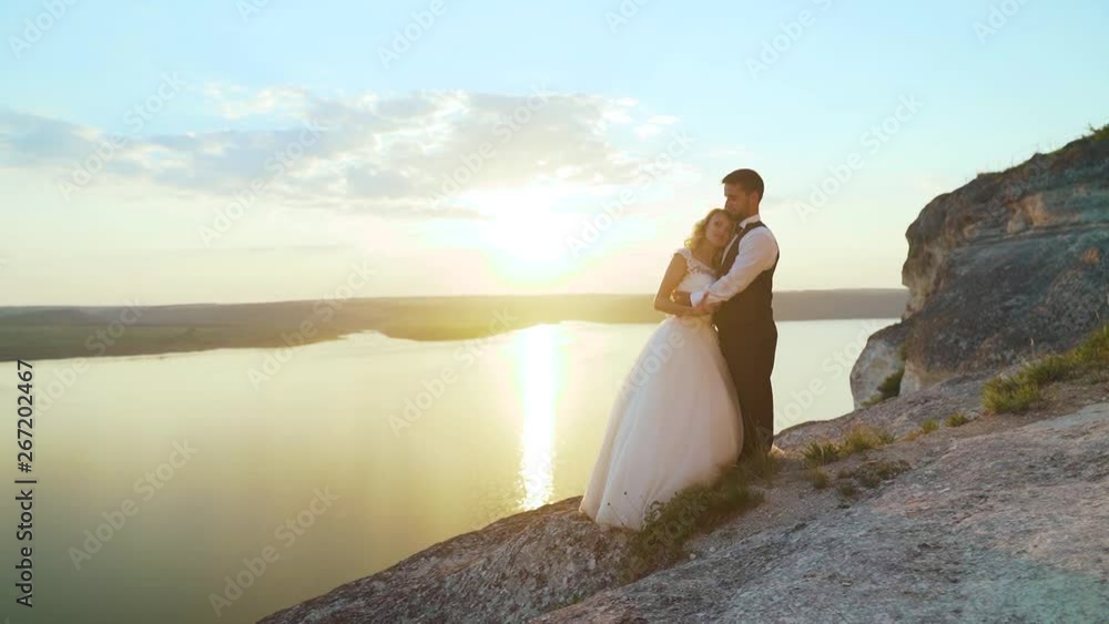 Couple walks out to ocean cliffs, takes in view together. Slow motion. Couple walks out to ocean cliffs, takes in view together. Slow motion.