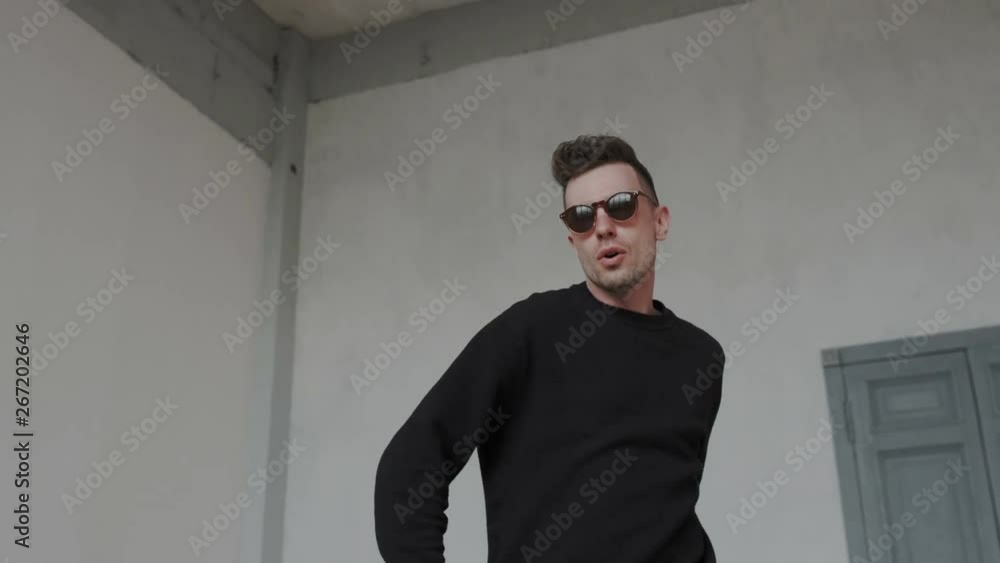 Cheerful young guy is dancing in euphoria. He dancing modern cool choreography alone at home. Passion handsome guy wearing black, dancing authentic choreography Cheerful young guy is dancing in euphoria. He dancing modern cool choreography alone at home. Passion handsome guy wearing black, dancing authentic choreography