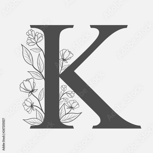 Uppercase Letter K with flowers and branches. Vector flowered monogram or logo. Hand Drawn concept. Botanical design branding. Composition of letter and flowers for wedding card, invitations, brand