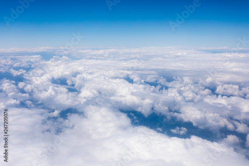Earth in the airplane window with clouds